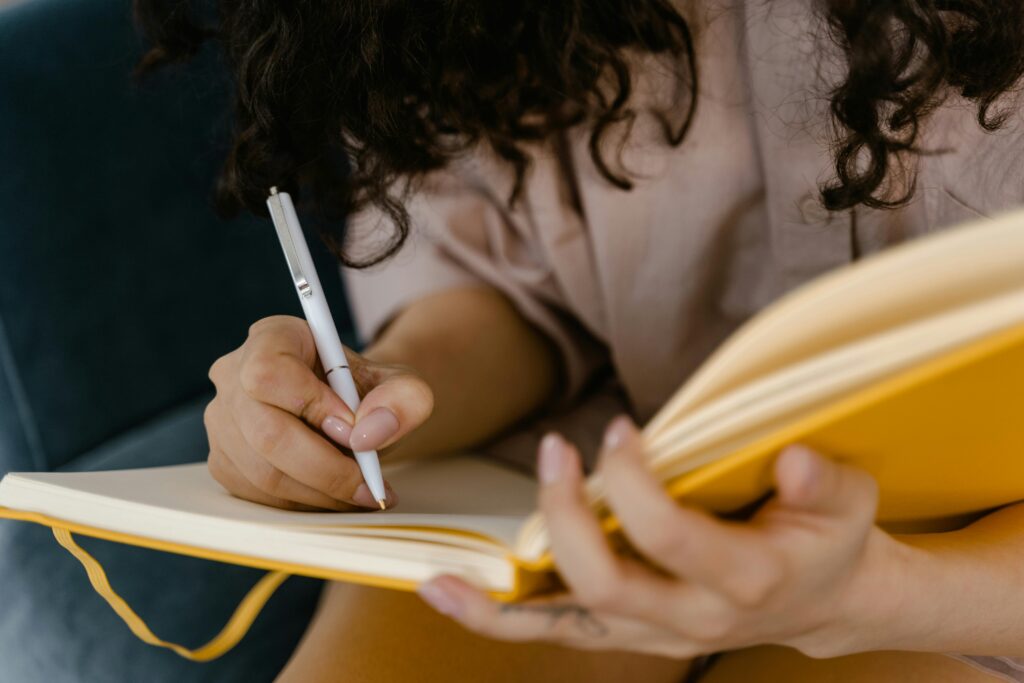 A woman writing in a journal.
