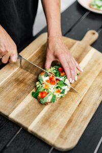 Person chopping a flatbread in half.