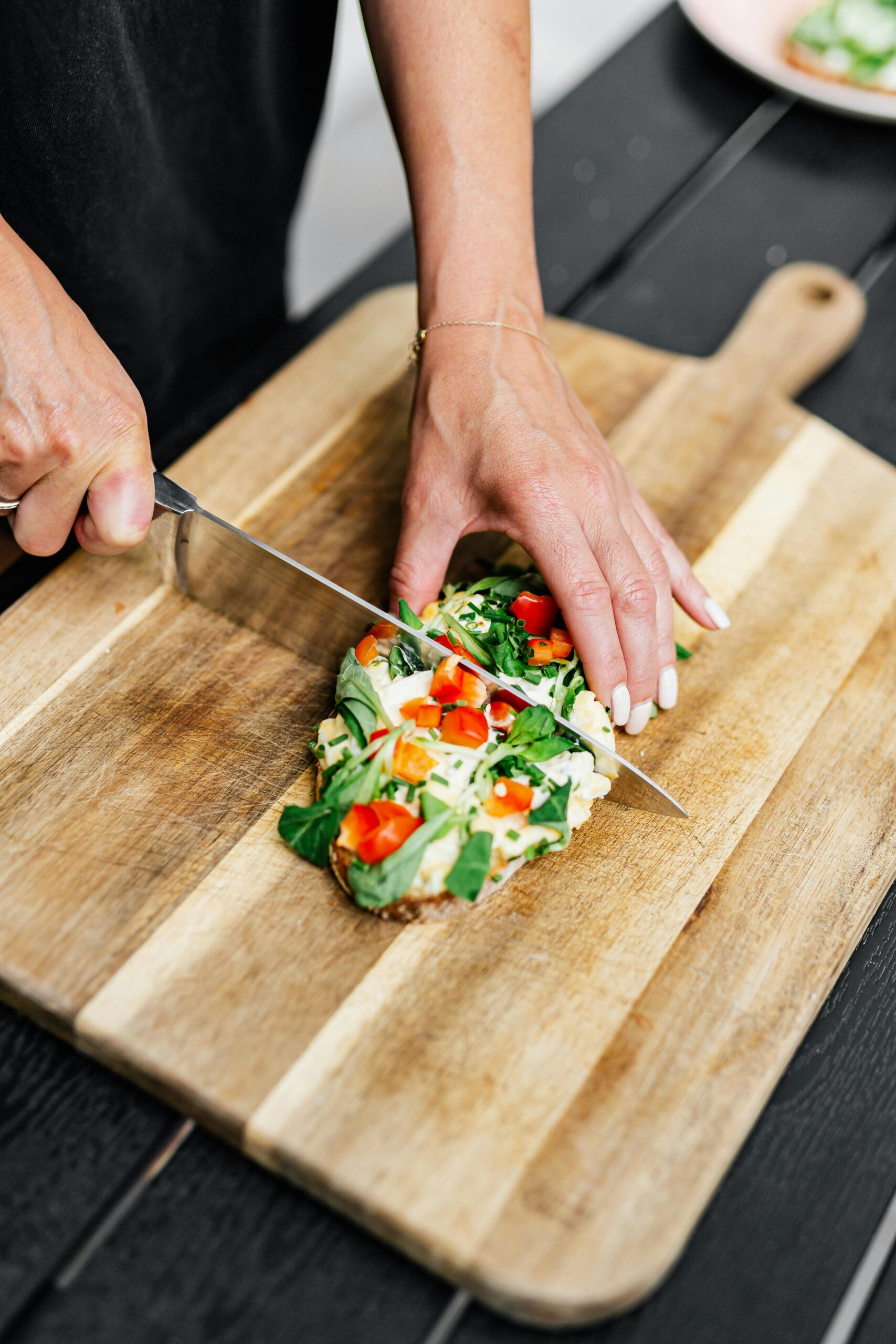 Person chopping a flatbread in half.