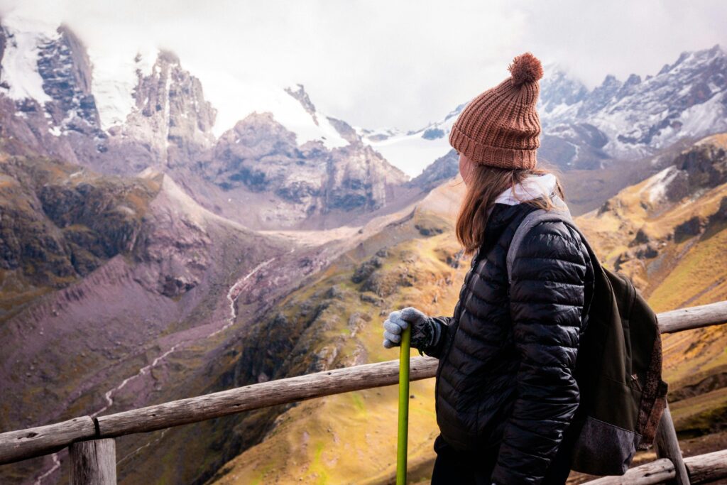 A woman on a hike, overlooking a canyon. 