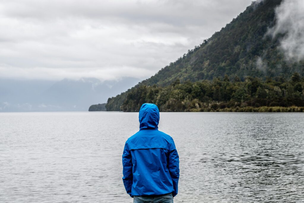 A person standing in front of a body of water.