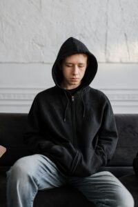 Young man sitting on a couch.