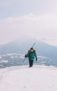 Woman hiking a mountain in the winter.