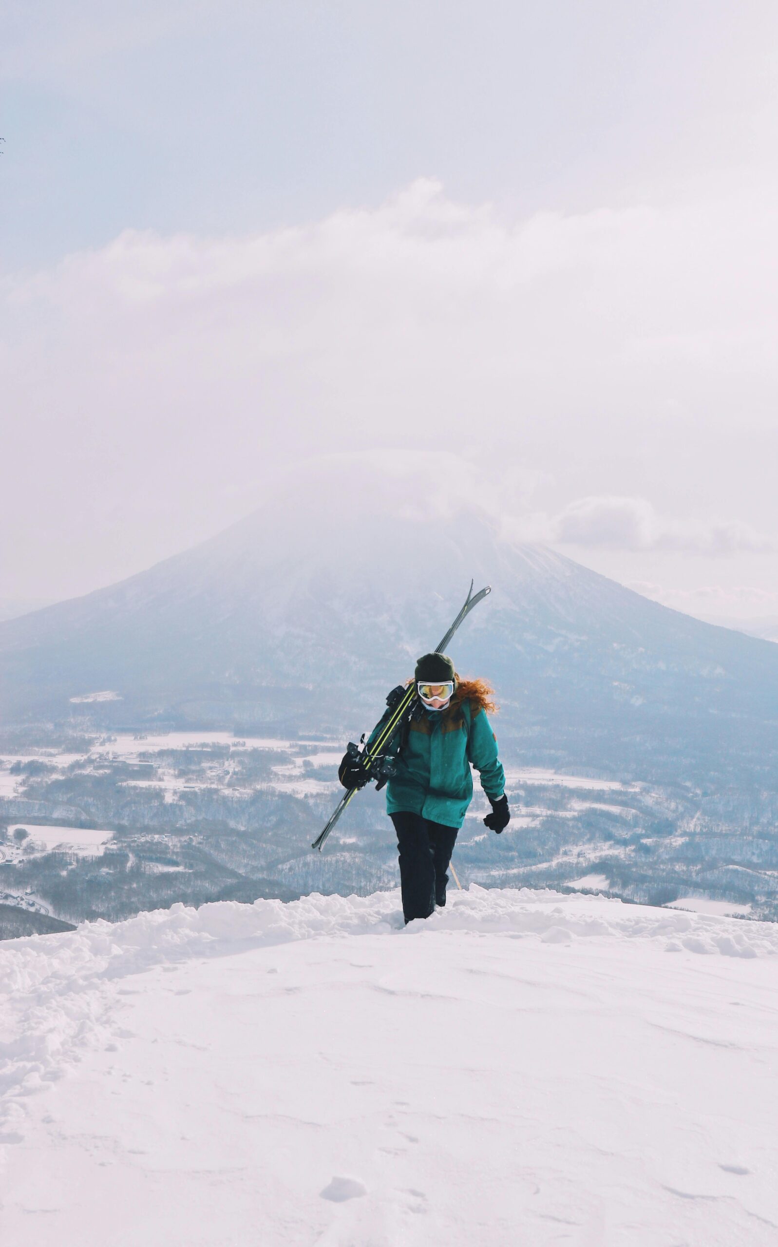 Woman hiking a mountain in the winter.