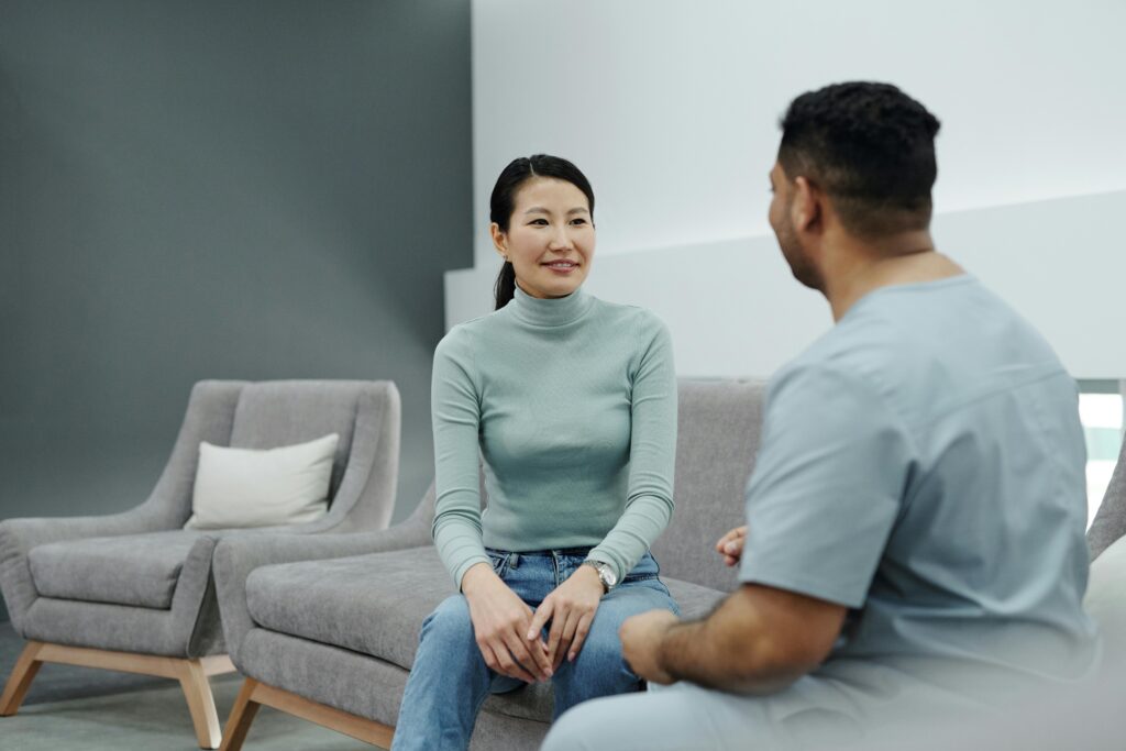 A woman sitting with her doctor or nurse.