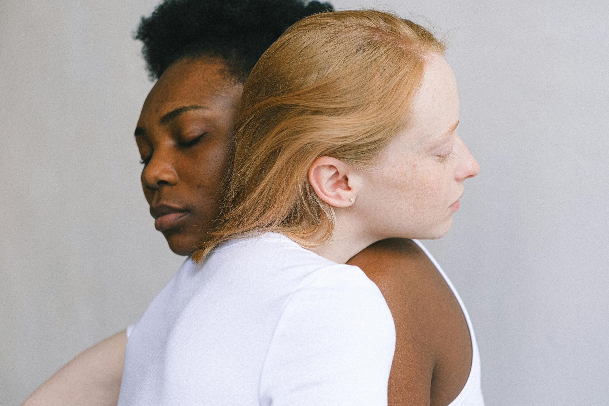 Two women hugging each other.