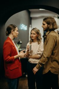 A woman socializing with two other people.