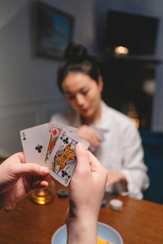 Two people playing cards with one another.
