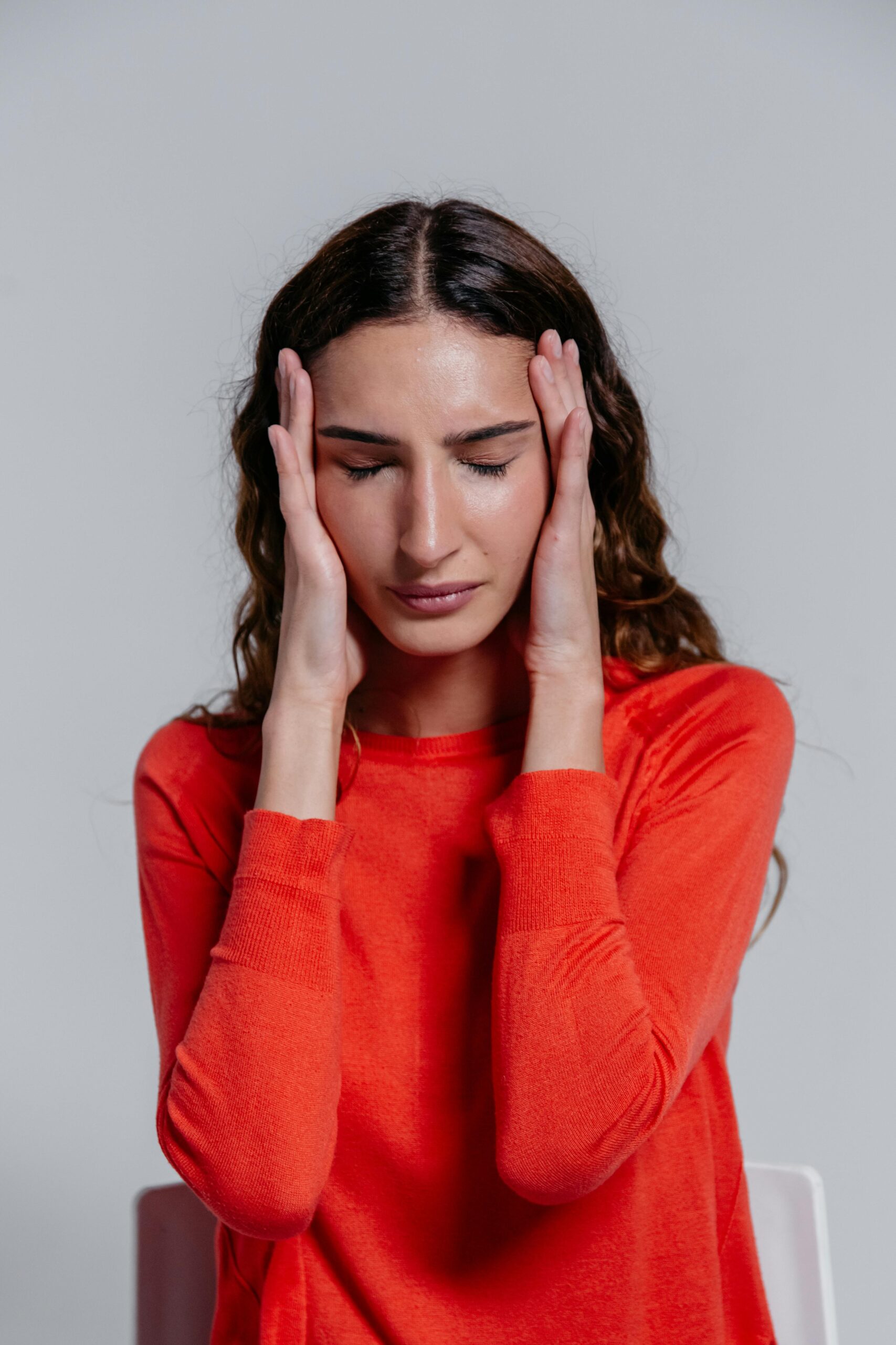 A woman struggling with an alcohol addiction from repeated alcohol abuse.
