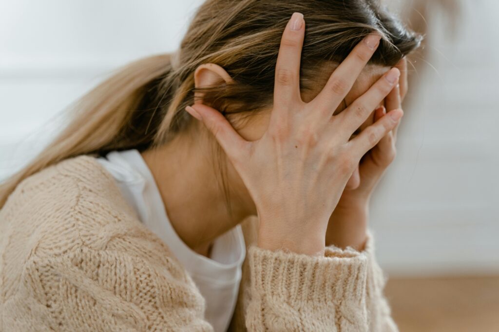 A woman struggling with an alcohol addiction from repeated alcohol abuse.