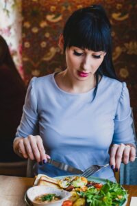 A woman eating mood-boosting foods for mental health.