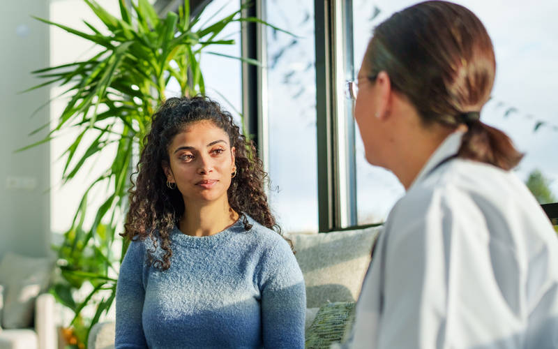 A woman learning about the outpatient program offerings at Luna Recovery for Women in North Andover, MA.