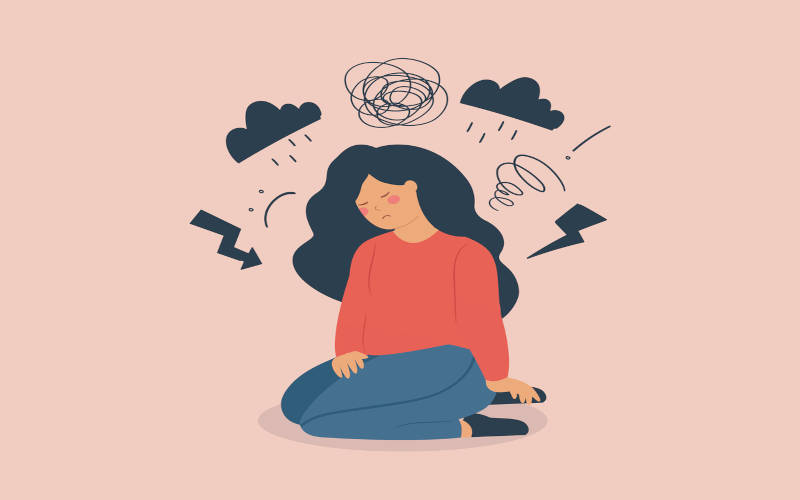 A cartoon woman kneeling on the ground with small cartoonish clouds of rain above her head, symbolizing depression.