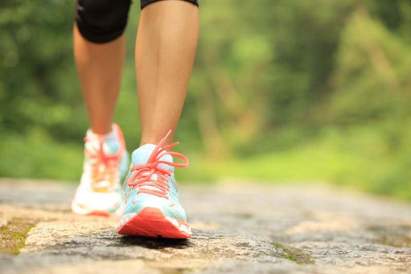 A woman on a walk, practicing a healthy coping mechanism, instead of reverting to self-medication.
