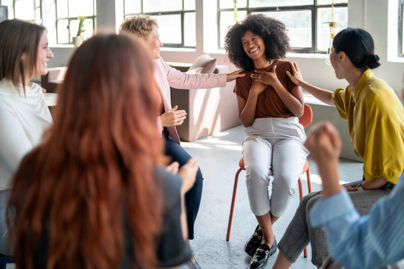 A group of women in therapy learning about the differences between alcohol addiction and drug addiction.