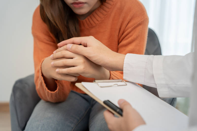 A woman in therapy learning how detox and addiction treatment both matter for healing.