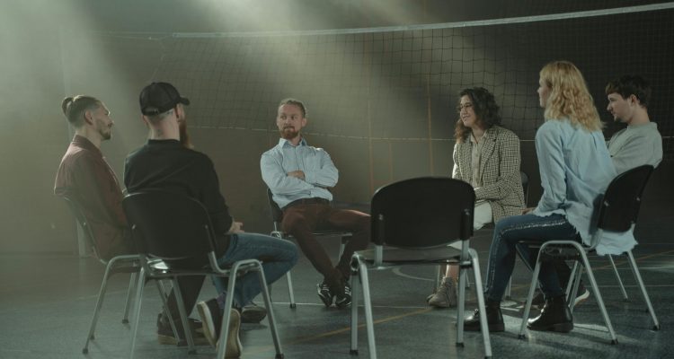 A group therapy session in a gym.